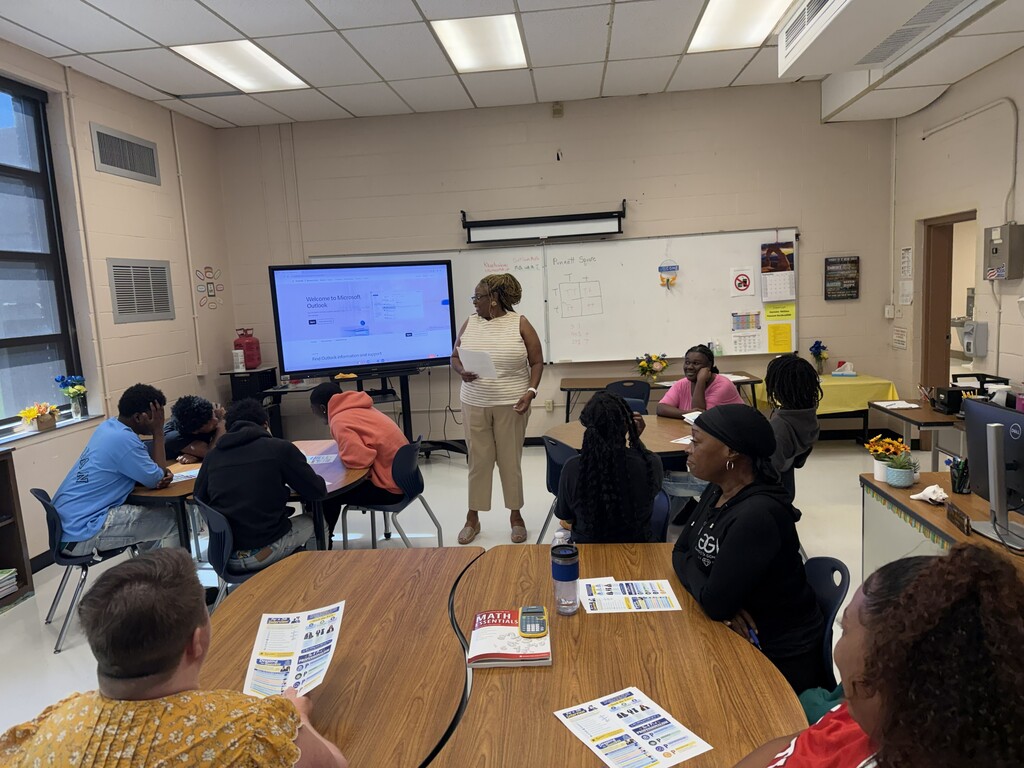 Students seated around tables in a classroom engaging in the professional skills workshop.