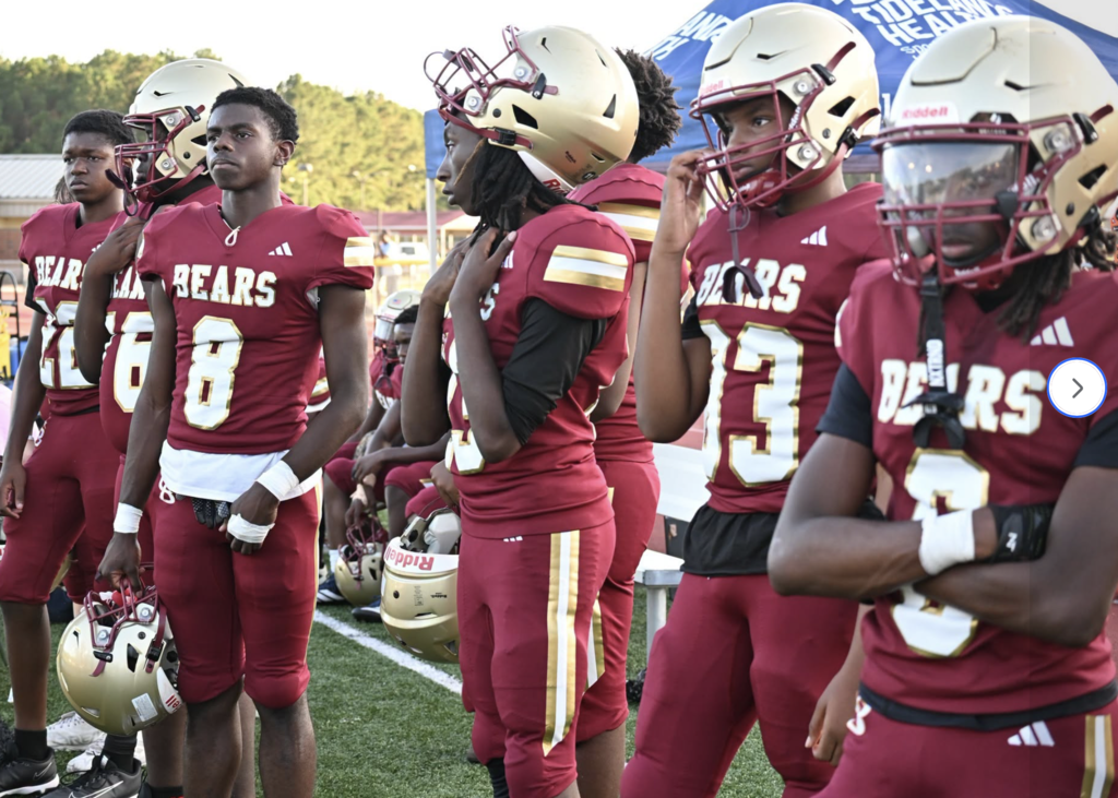 Middle school and high school JV players on the sidelines
