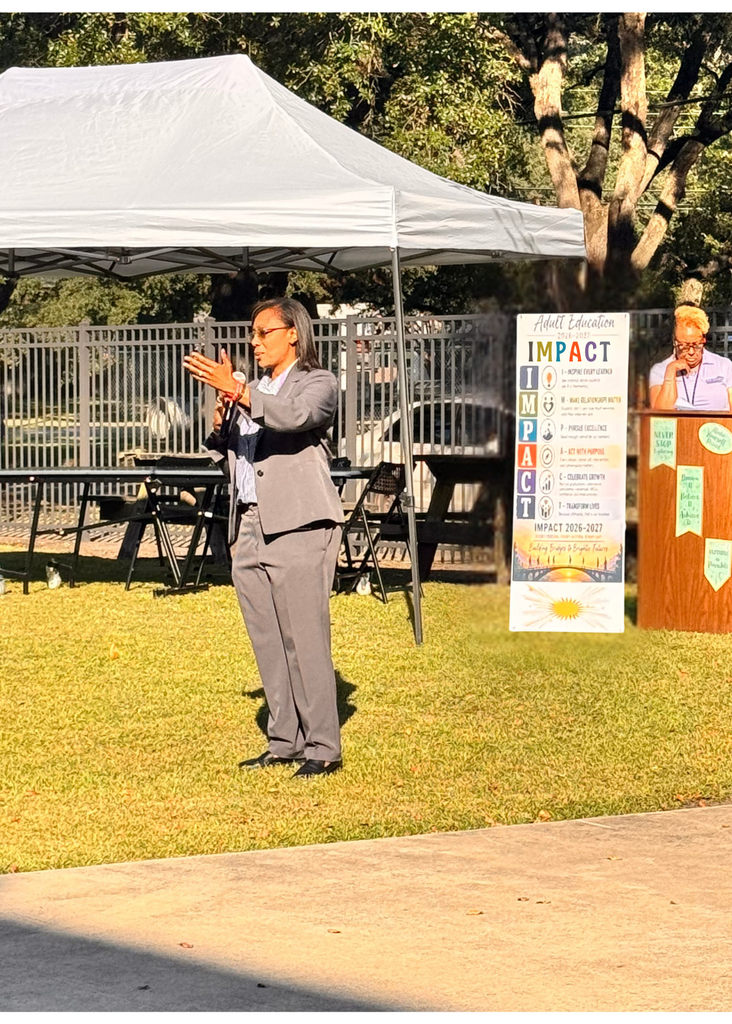 Dr. Bethany A. Giles, GCSD Superintendent, sharing powerful words about the IMPACT literacy has on our students, families, and community with GCAE Director, Dr. Paula Anderson in the background at a podium next to the GCAE IMPACT sign which reads: Georgetown County Adult Education IMPACT values poster with tagline "Learn • Grow • Belong • Succeed" and "People • Purpose • Progress." Six colored rows display IMPACT acronym: I - Inspire Every Learner (believe in potential and lifelong learning); M - Make Relationships Matter (build inclusive, supportive connections); P - Pursue Excellence (committed to high-quality programs and continuous improvement); A - Act With Purpose (make intentional decisions creating opportunities); C - Celebrate Growth (recognize progress and honor achievements); T - Transform Lives (open doors and create possibilities for brighter futures). Bottom features photograph of bridge at sunset representing "Building Bridges to Brighter Futures." Includes motto "Every Person. Every Action. Every Day." and signature of Dr. Paula Anderson, Director.