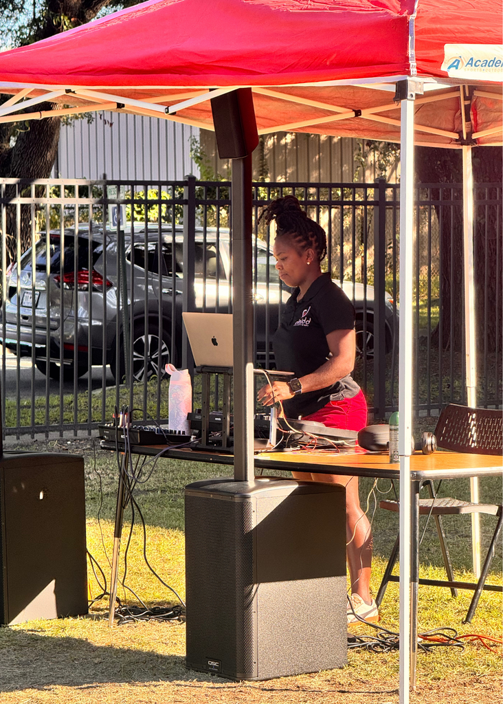 DJ Midd (aka Denetria Middleton) in the DJ tent.