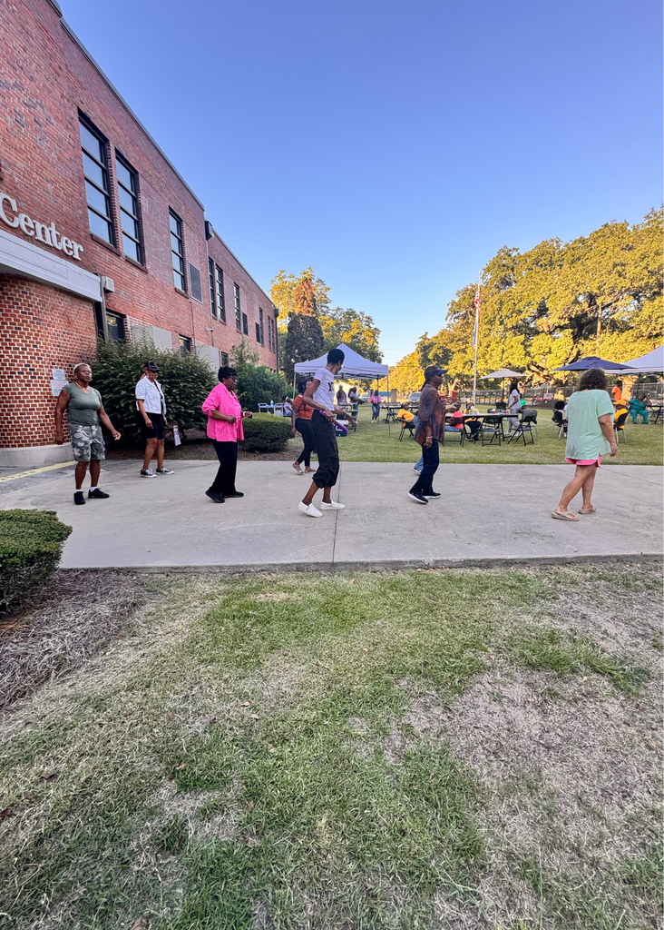 GCAE Community dancing in front of the school.