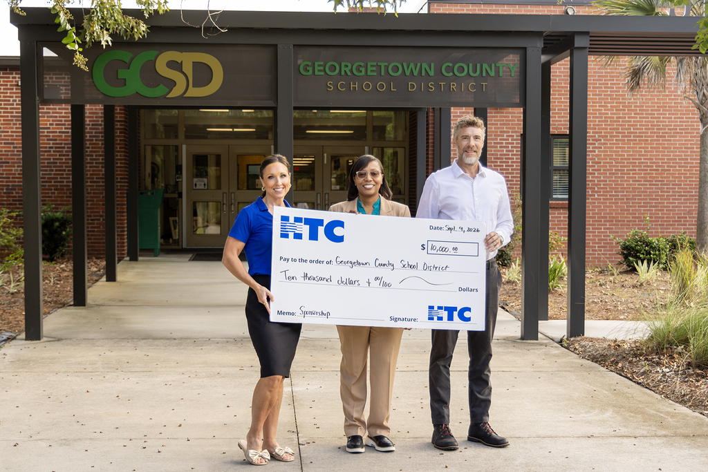 HTC presents a check to Superintendent Giles (center)
