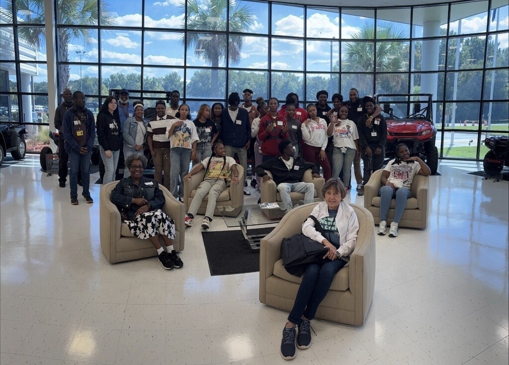 Students posing in honda