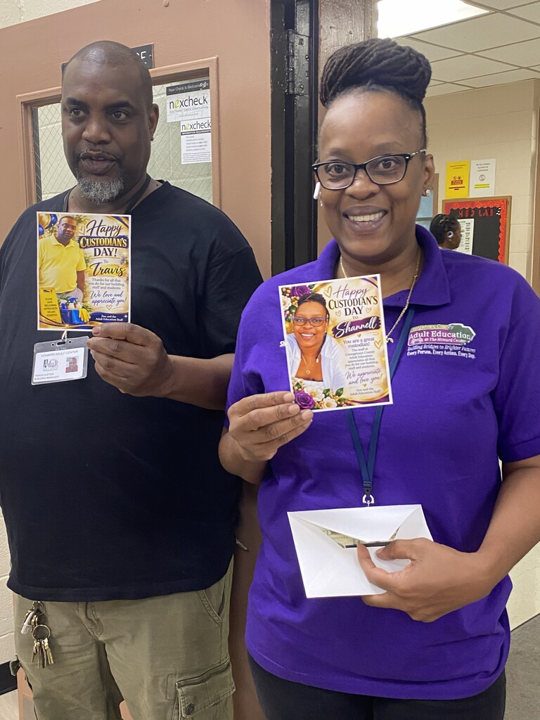 Mr. Travis Alston and Ms. Shannell Greene, custodians at Georgetown County Adult Education, stand together holding personalized "Happy Custodians' Day" appreciation cards from the staff.