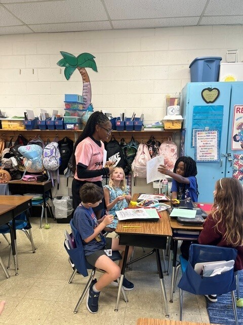Melissa Jefferson-Wooden visits a Waccamaw Elementary classroom and speaks with students gathered around their desks.