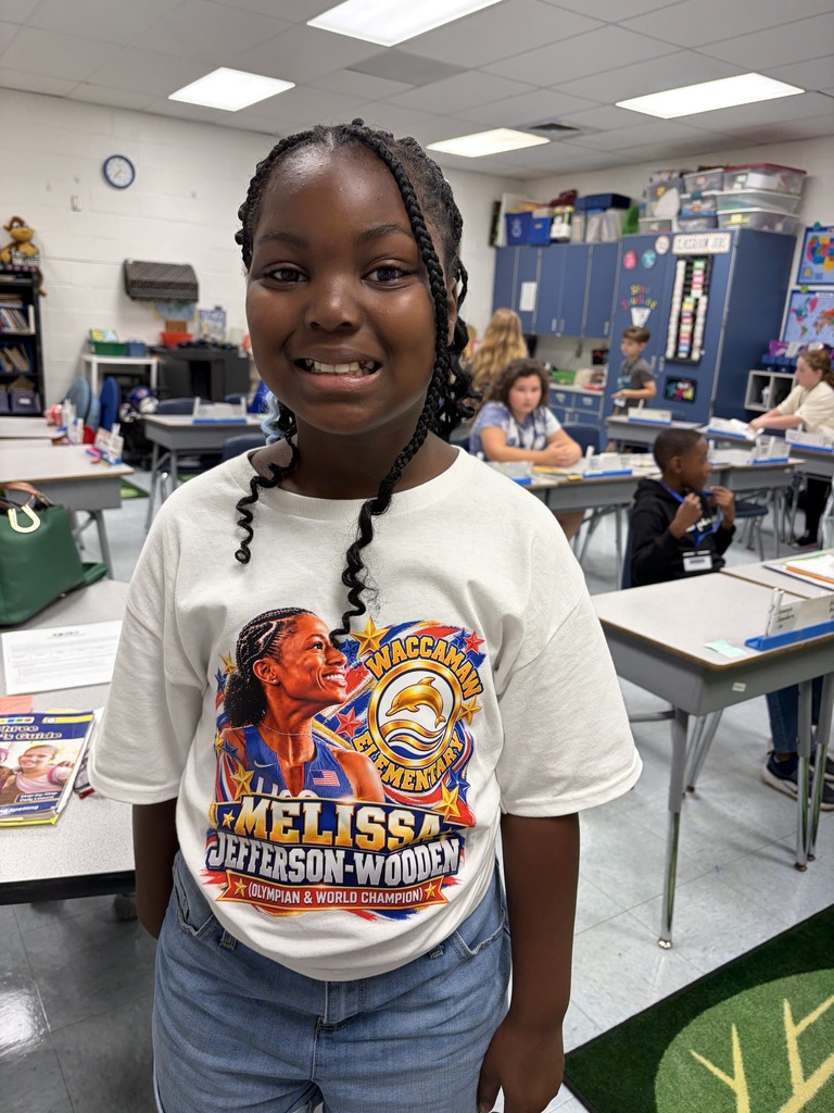 A Waccamaw Elementary student smiles while wearing a Melissa Jefferson-Wooden shirt featuring her image and the school logo.