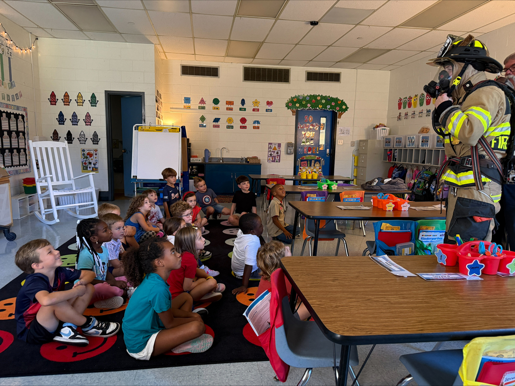 Waccamaw Elementary students watch attentively as a Midway Fire Rescue firefighter in full protective gear demonstrates equipment during a classroom fire safety presentation.