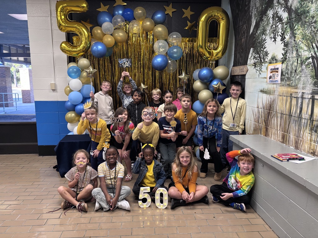 Students pose together at the decorated photo station
