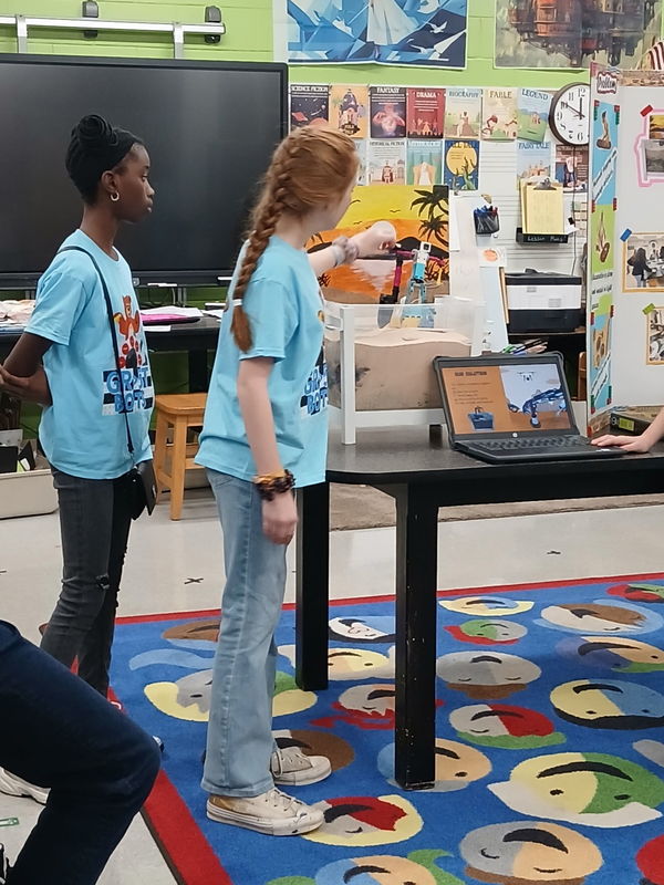 Another picture of our students during the Sterling Scrimmage. They are wearing blue t-shirts.