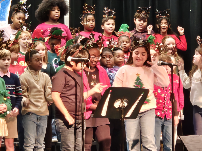 3rd Graders singing on stage