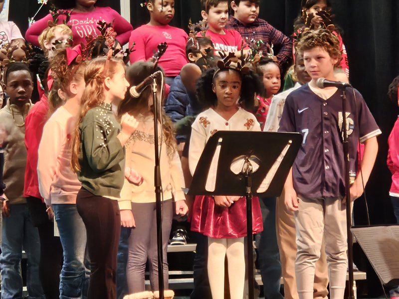3rd Graders singing on stage