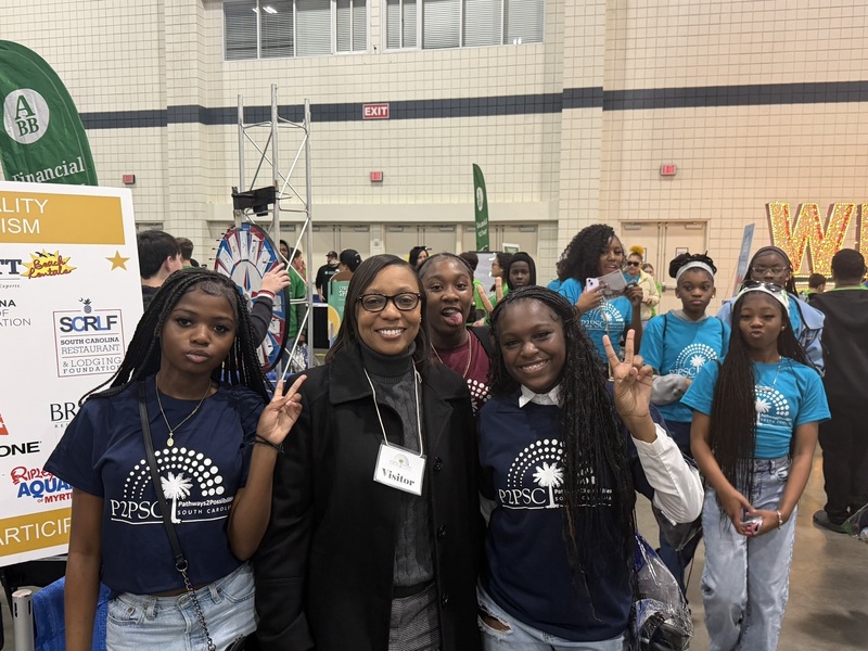Students pose with Superintendent Giles.