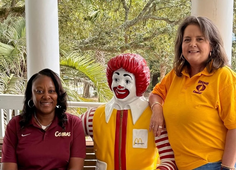 Mrs. Dennison and Mrs. Glisson posing with Ronald McDonald statue