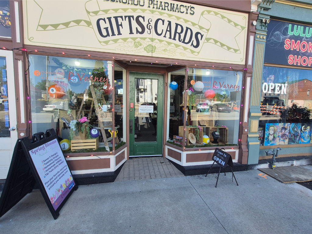Image of piñatas hanging in the window of Donohoo Pharmacy