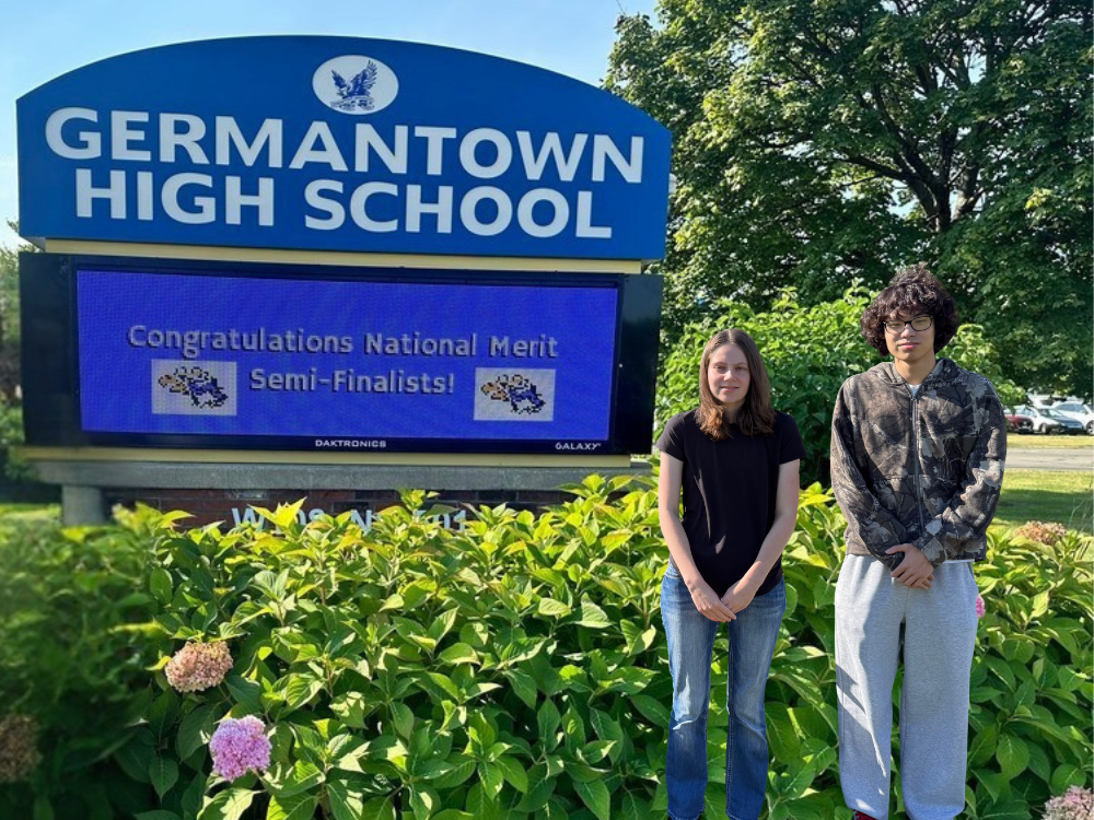 Eden Jones and Daniel Xu stand outside Germantown High School with the sign in the background as they are congratulated for their National Merit Semifinalist recognition.