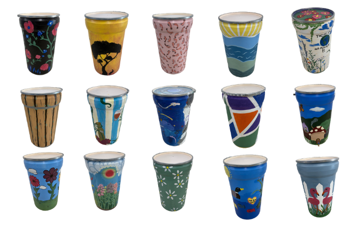 A collection of hand-painted rain barrels designed by Germantown High School students for the annual silent auction, featuring colorful nature themes and artistic patterns.
