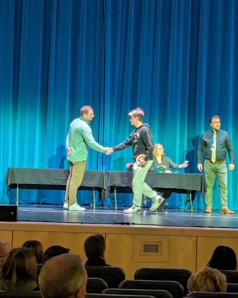 Principal Smith along with Mr. Rooney and other high school staff awarded high school students academic letters on stage.