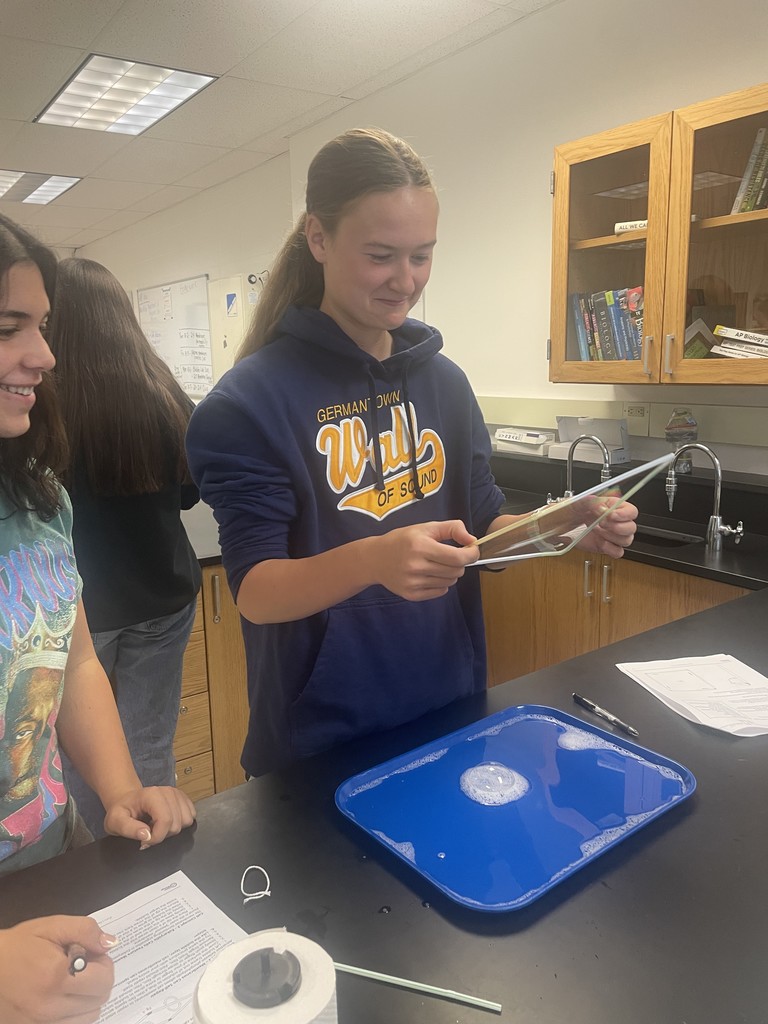 A student moves a bubble in AP Biology class learning how they relate to the cell membranes students are learning about in class.