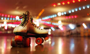 a pair of roller skates on a rollr rink floor with disco lighting