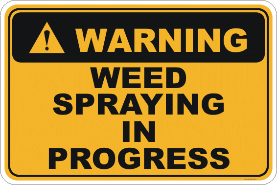 A yellow sign with a warning symbol and text that says "Warning, Weed Spraying in Progress"