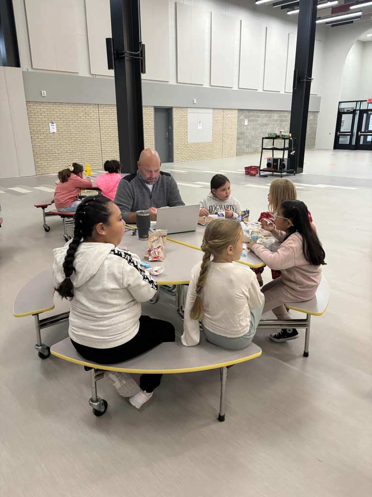 Mr Werner with kids at a table