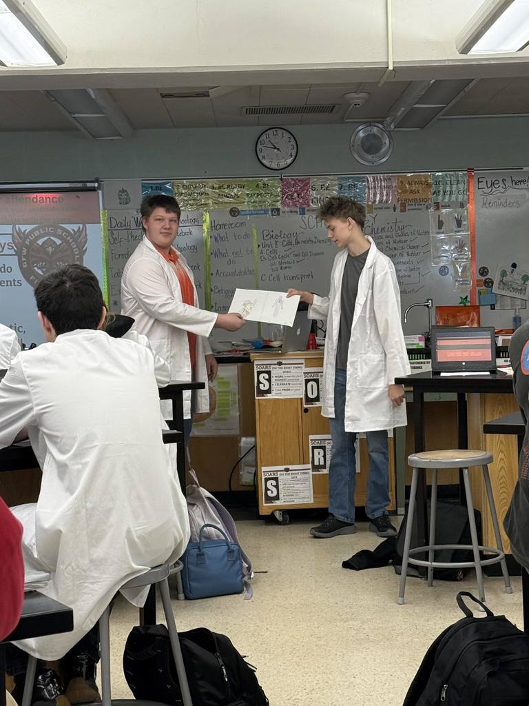 Students giving a biology presentation 