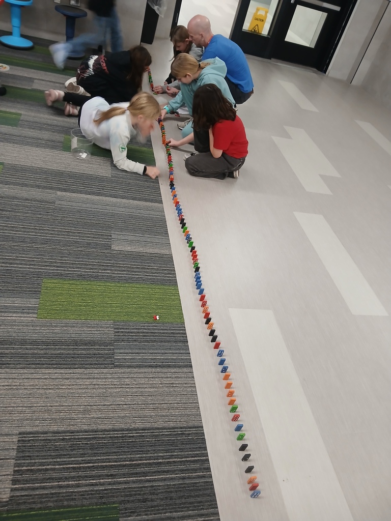 Students building dominoes 