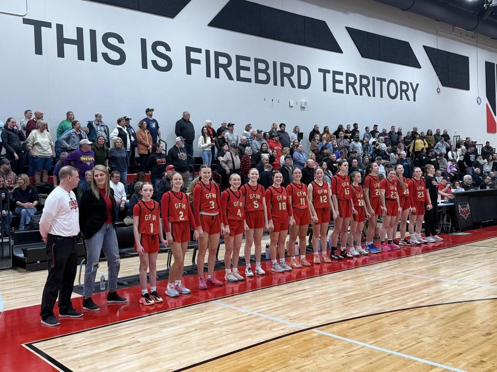 Basketball players lined up on sideline