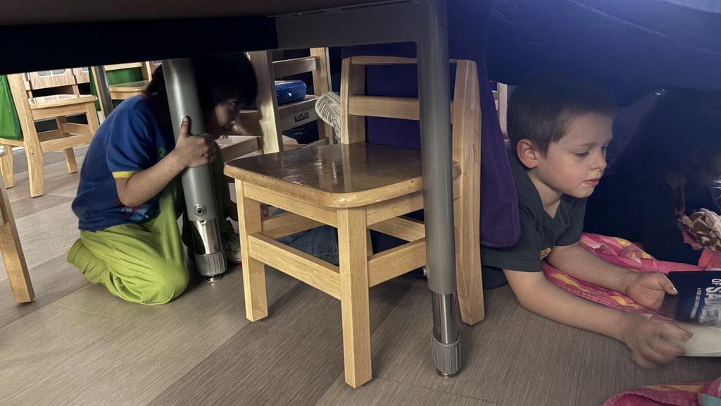 kids reading in a fort