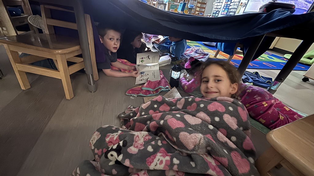 kids reading in a fort