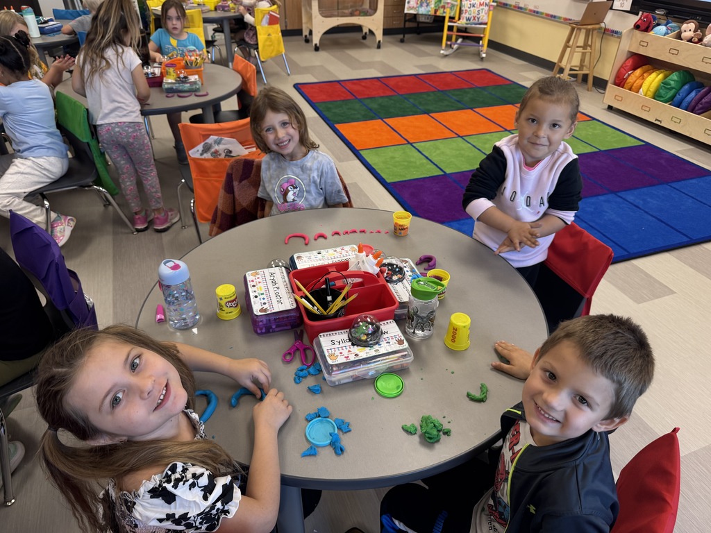 Students around a table with playdoh