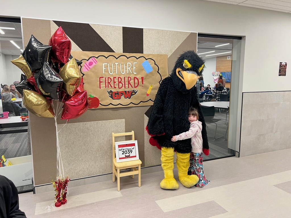 Future firebird pose with student and mascot