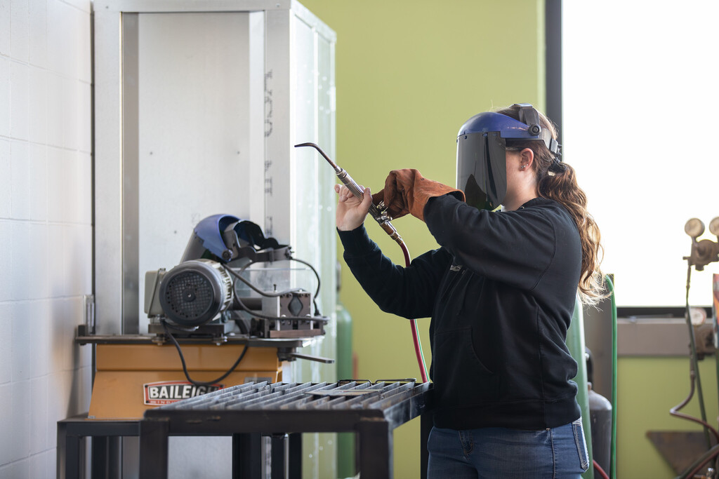 student with welding tools