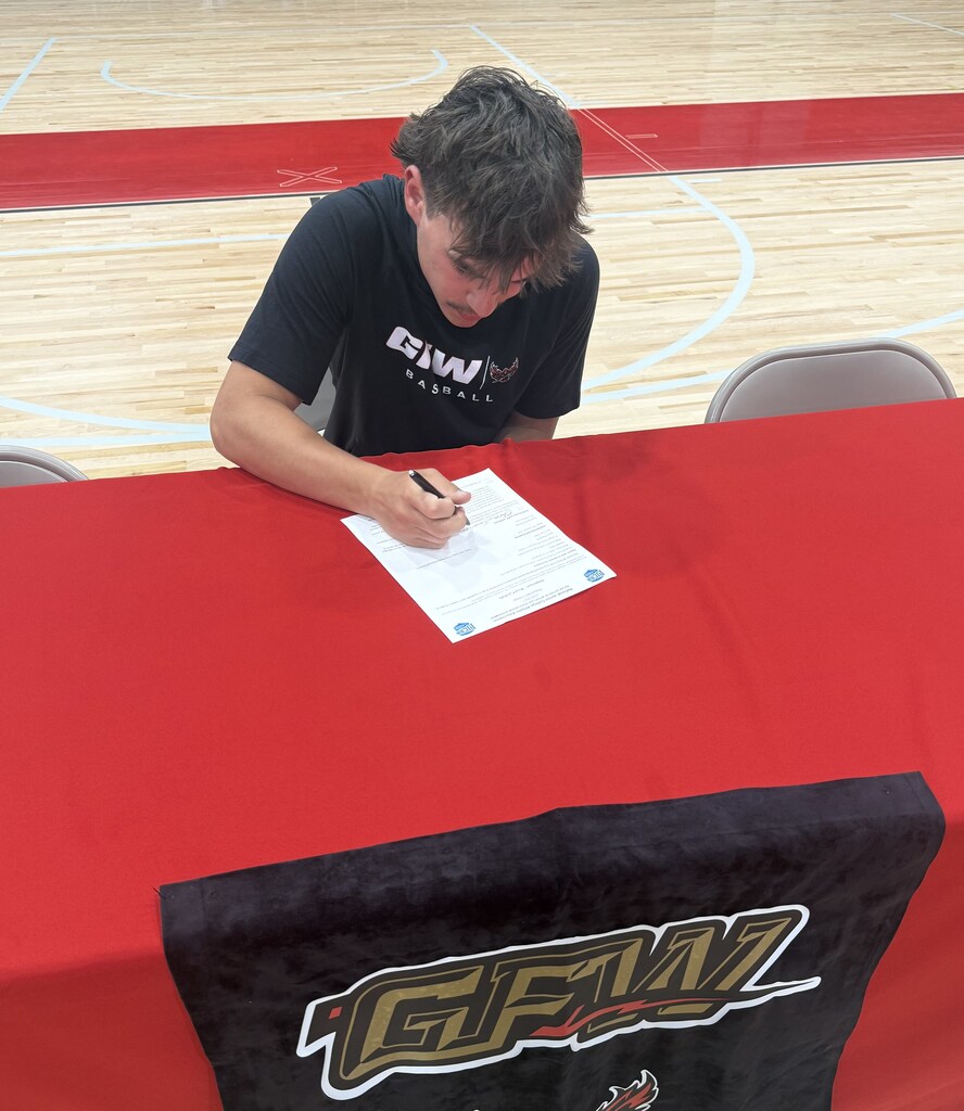 Student signing letter
