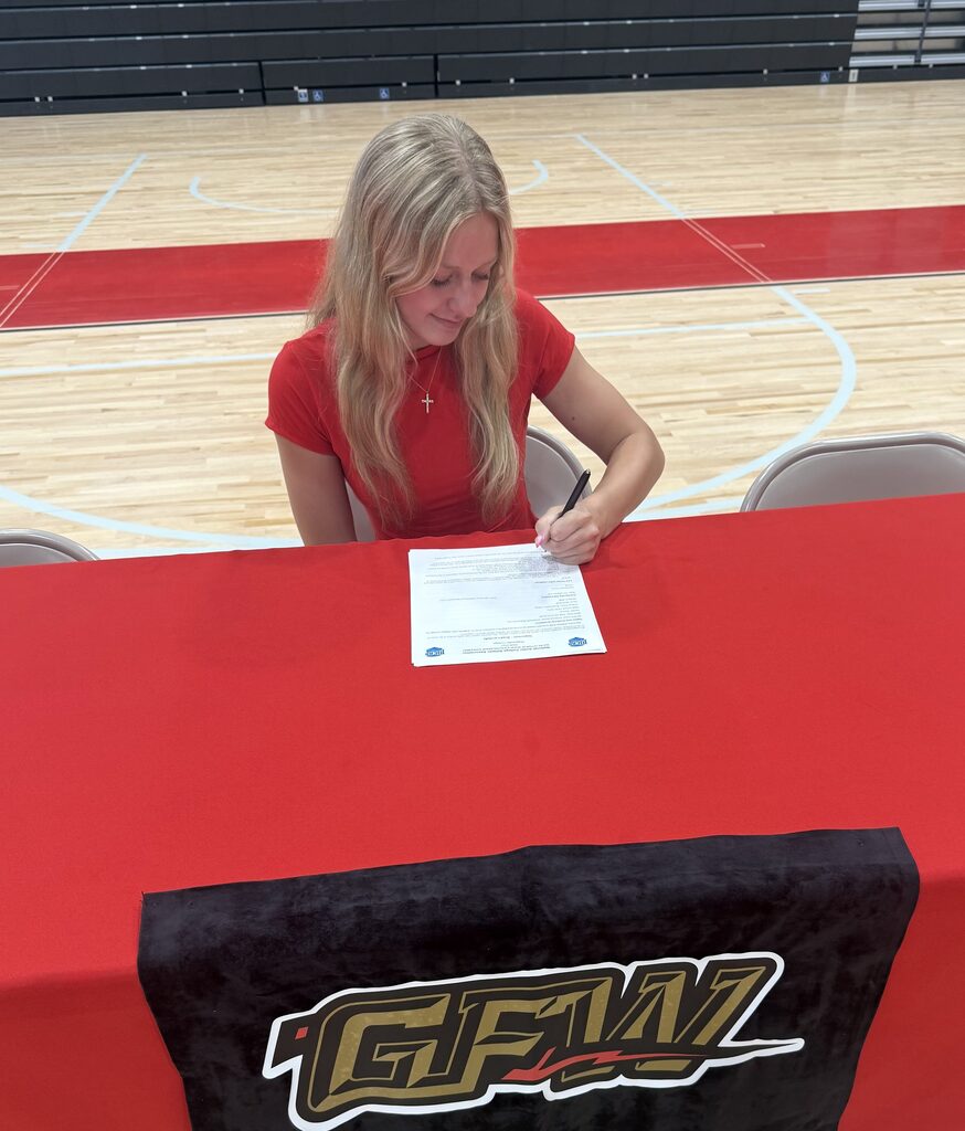 Student signing letter