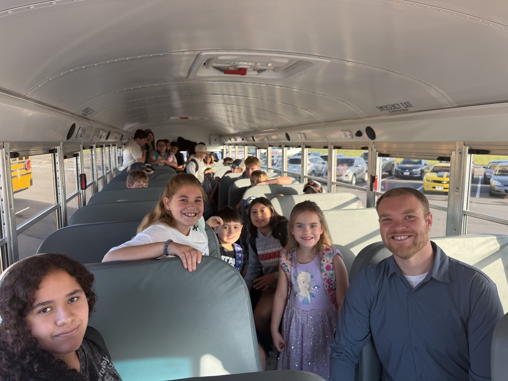 Superintendent and students on a bus