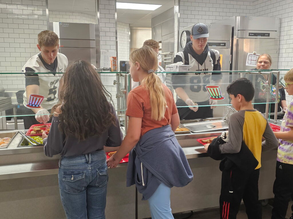 Football players serving lunch