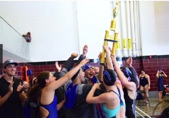 Girls swim teach with trophy
