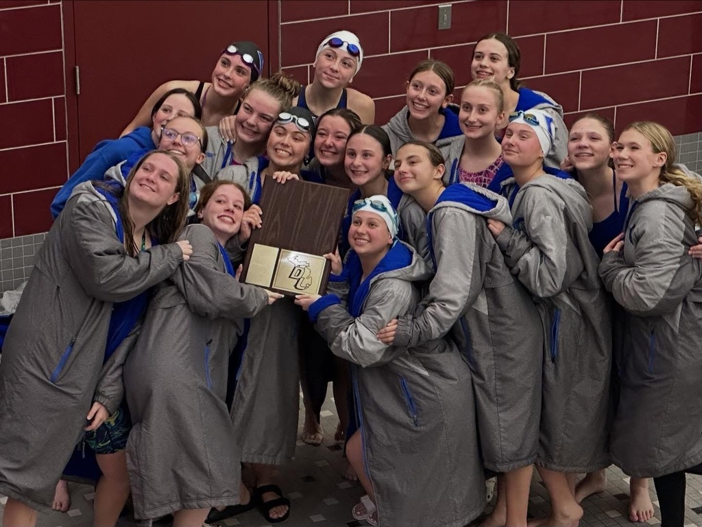 Girls swim team with trophy