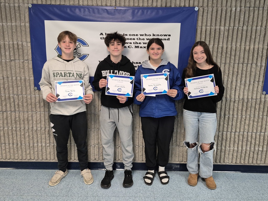 Four students with certificates
