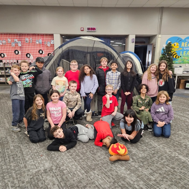 students standing in front of a tent at Camp Wanna Read