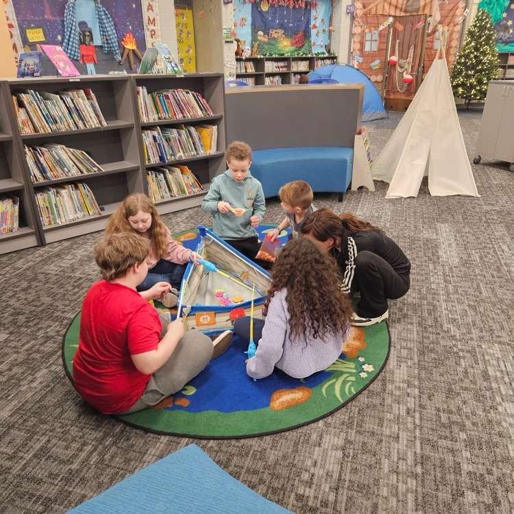 students using magnetic fishing poles at Camp Wanna Read