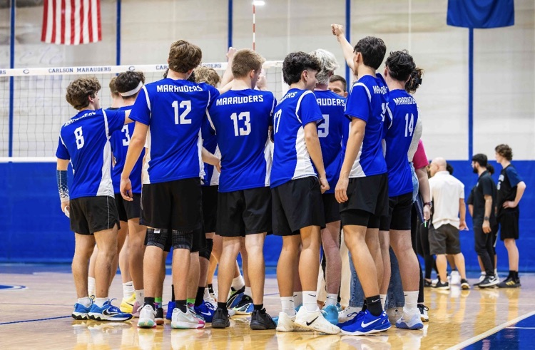 CHS Boys Club Volleyball team in a timeout talking 