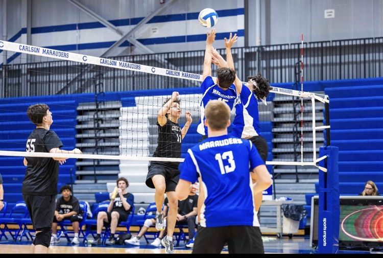 CHS Boys Club Volleyball team two players blocking 