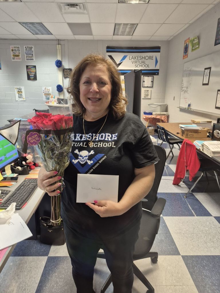LVS Secretary Mrs. Bilot holding flowers for Admin Assistant Day