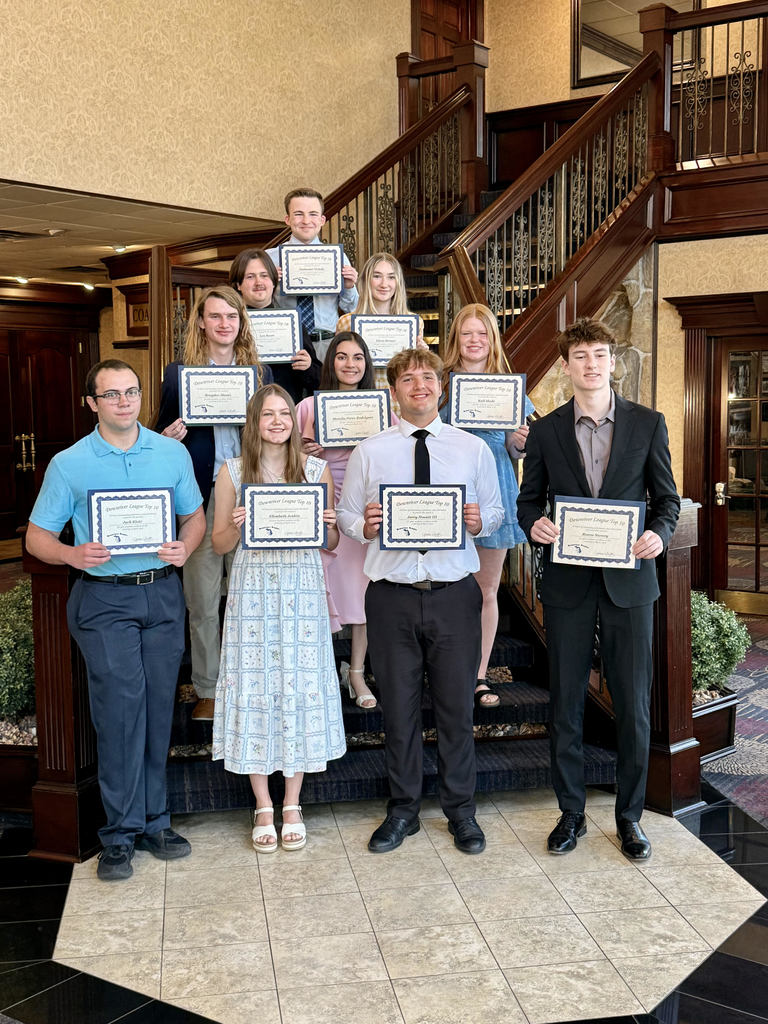 ten students dressed professionally each holding a certificate