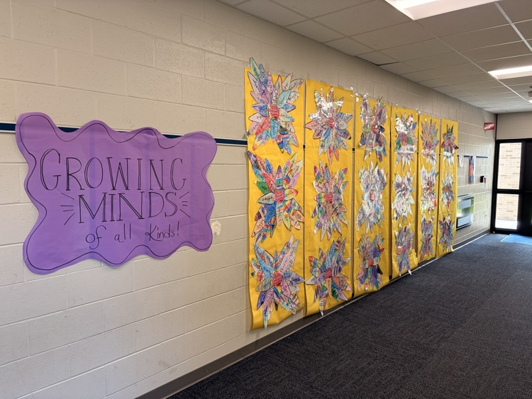 growing minds display for autism month in elementary hallway.