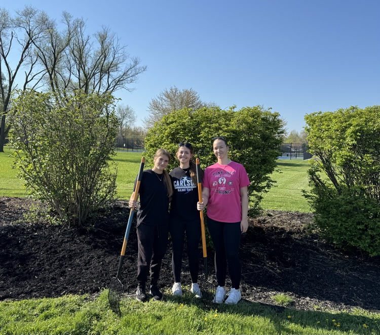 CHS Earth Club students posing in front of bushes ready to spread mulch