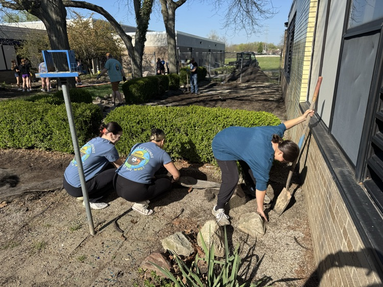 CHS Earth Club students moving rocks 