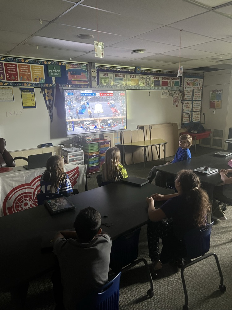 Elementary students watching Robotics competition in stem room